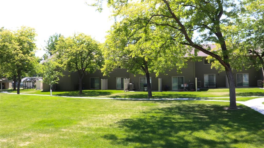 a building with trees and grass in front of it