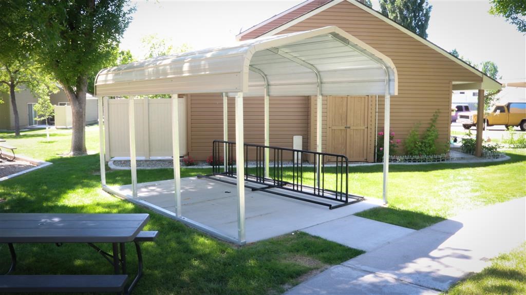 a screened in patio with a house in the background