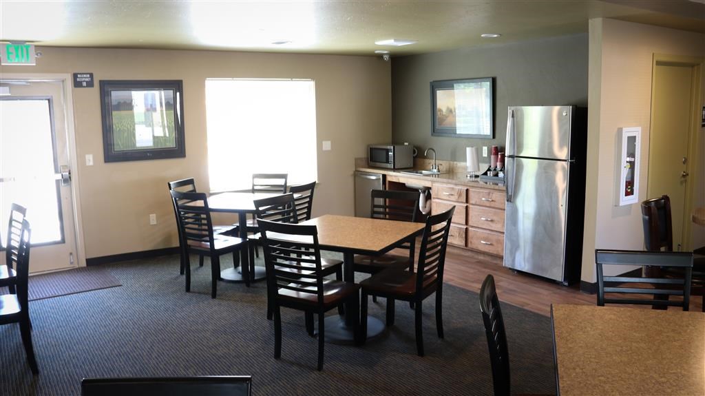 a kitchen and dining room with a table and chairs