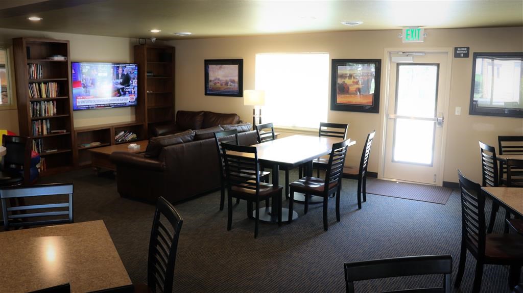a living room with a table and chairs