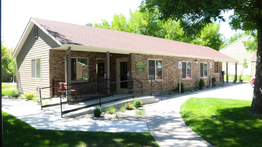 a small house with a porch and a driveway