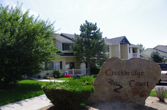 a stone sign in front of a neighborhood court house