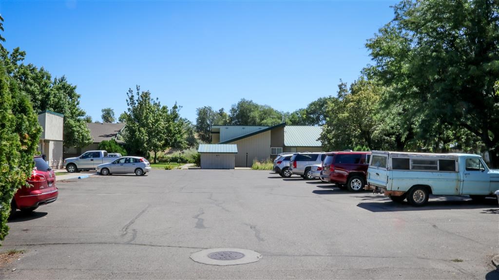 a parking lot filled with cars and a building