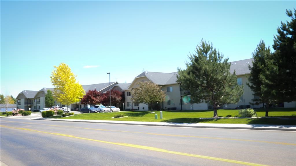 an empty street in front of an apartment building
