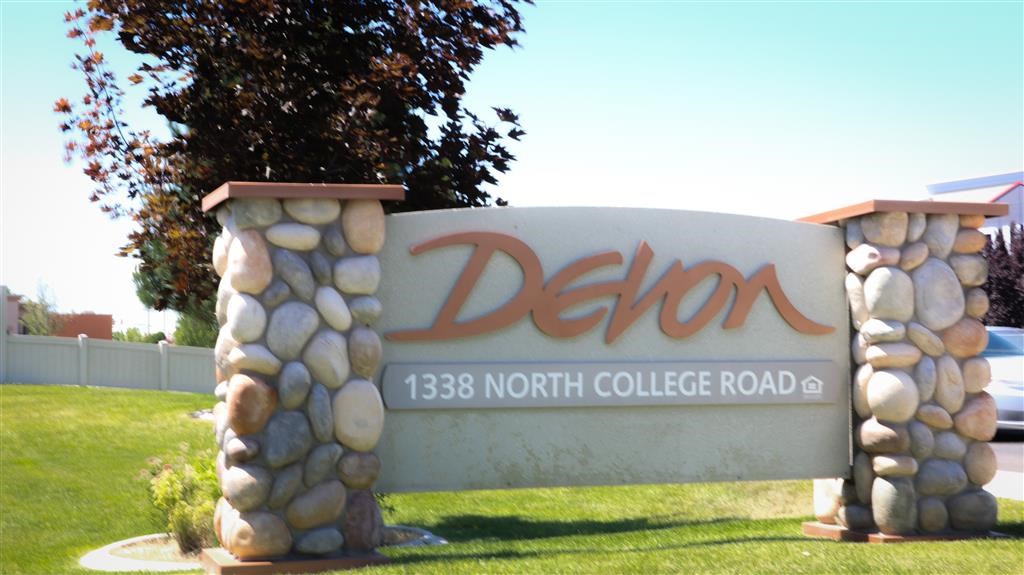 a sign in front of a tree