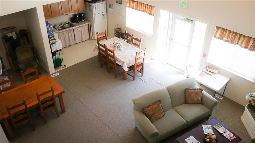 a living room and dining room with a table and a couch