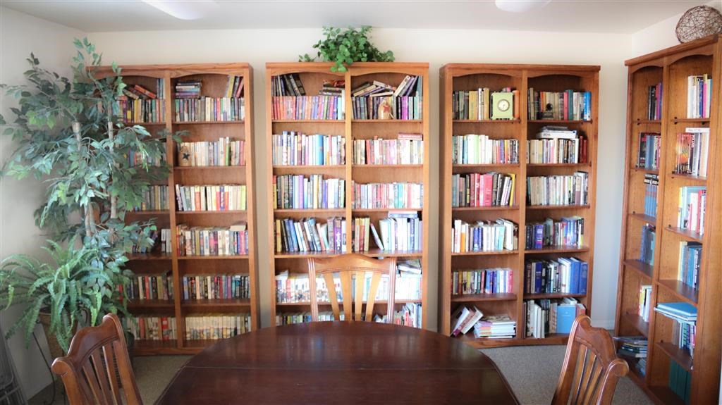 a dining room with a table and bookshelves