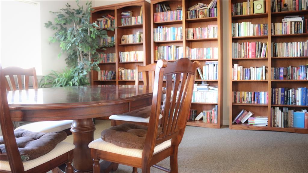 a library with a table and chairs in it