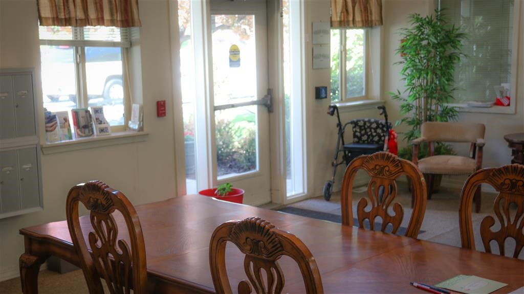 a dining room with a table and chairs