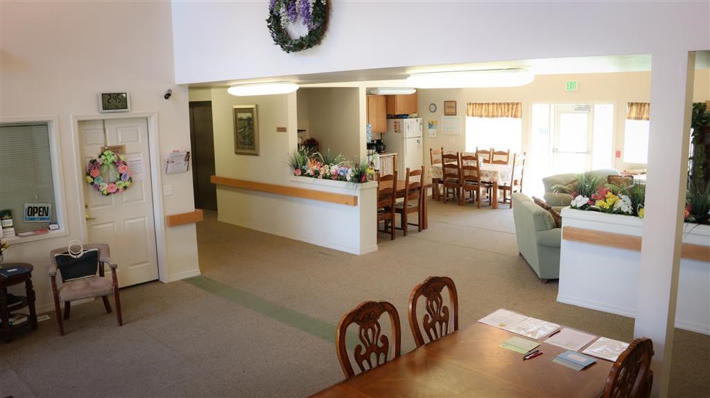 a living room and dining room with a table and chairs