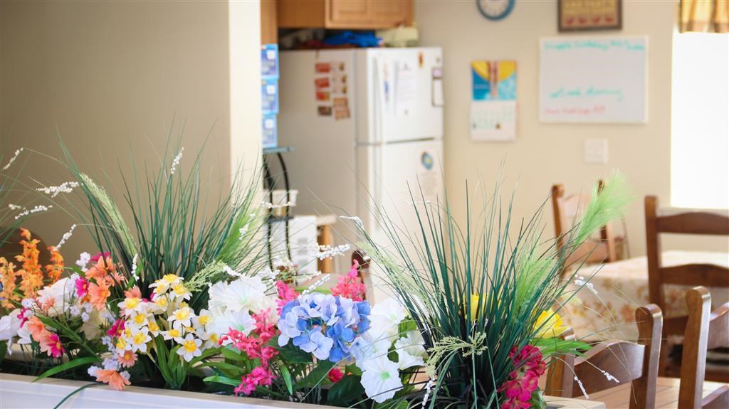 a bunch of flowers on a counter in a kitchen