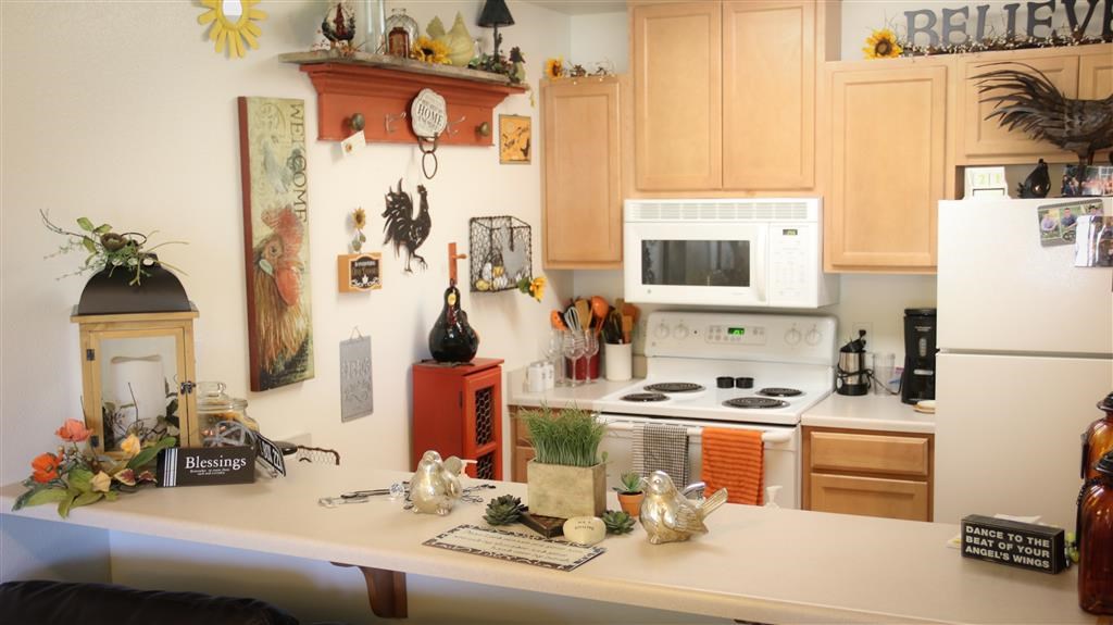 a kitchen with white appliances and a table