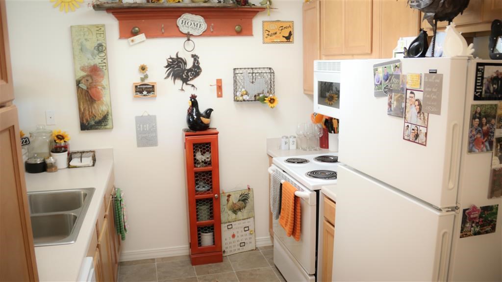 a kitchen with a stove refrigerator and a sink