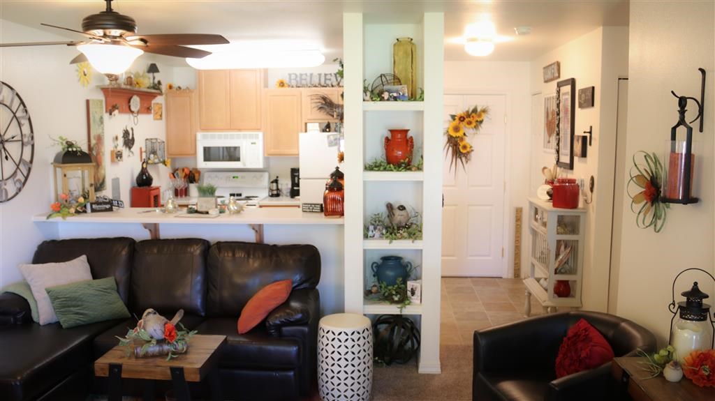 a living room with a couch and a kitchen