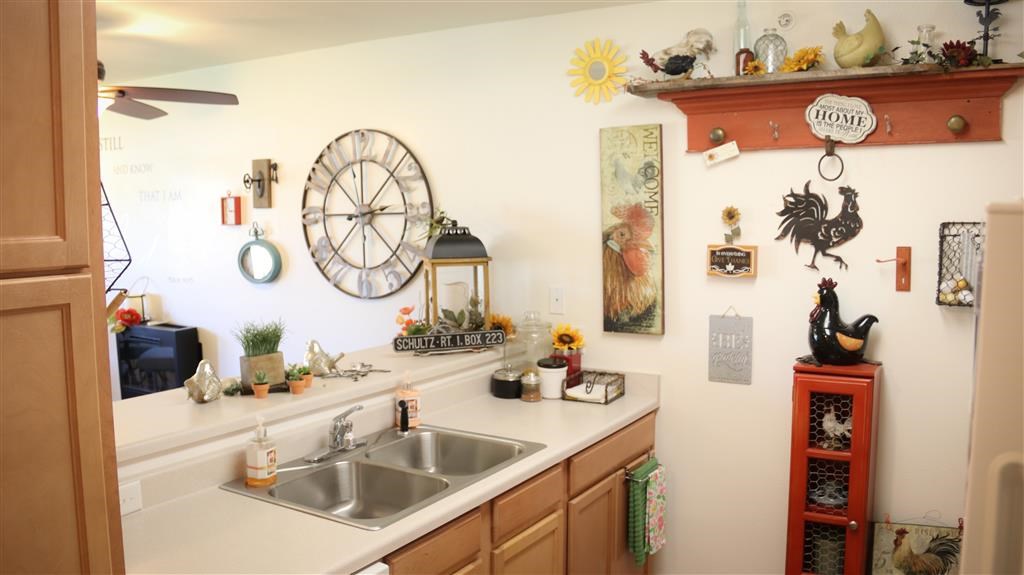 a kitchen with a sink and a clock on the wall