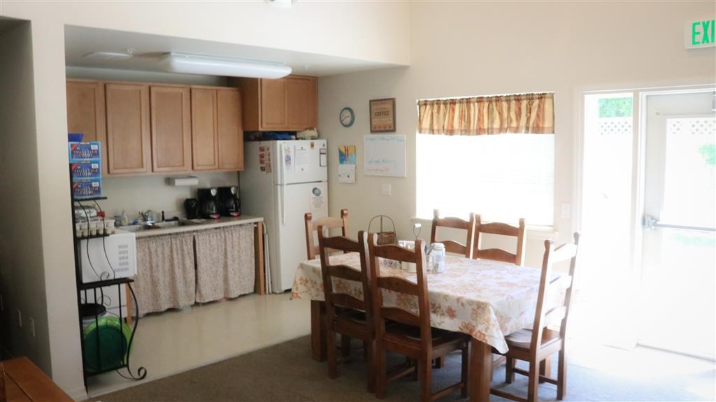 a kitchen with a dining table and chairs