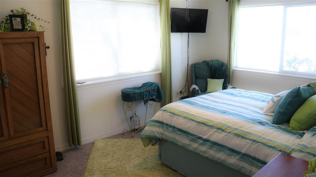 a bedroom with a bed and a chair