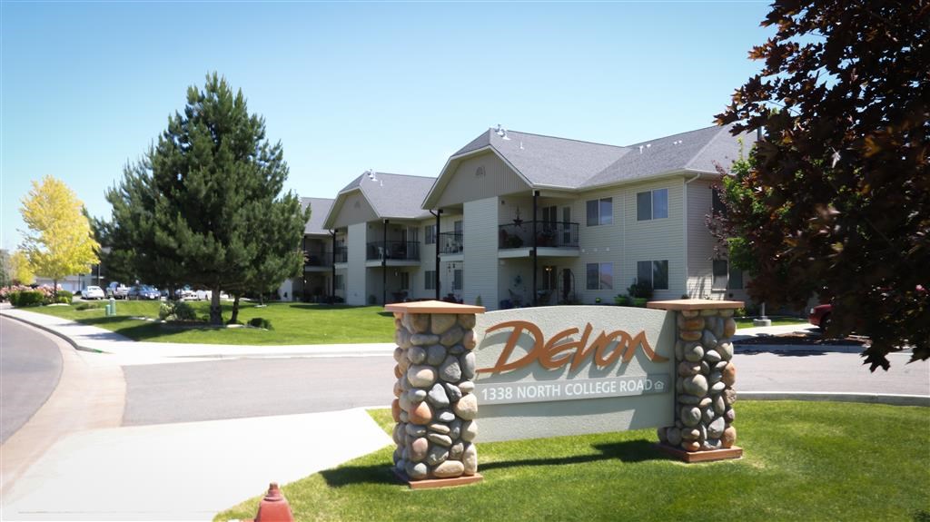 a sign in front of an apartment building