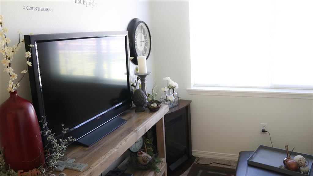 a tv sitting on top of a wooden table