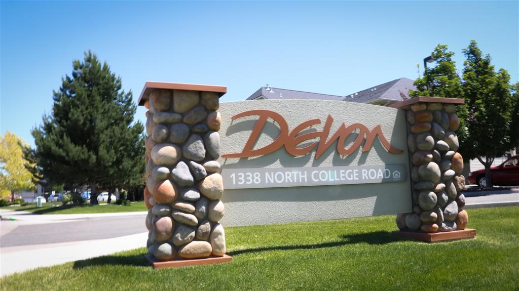 a sign for the delon north college road with rocks on it
