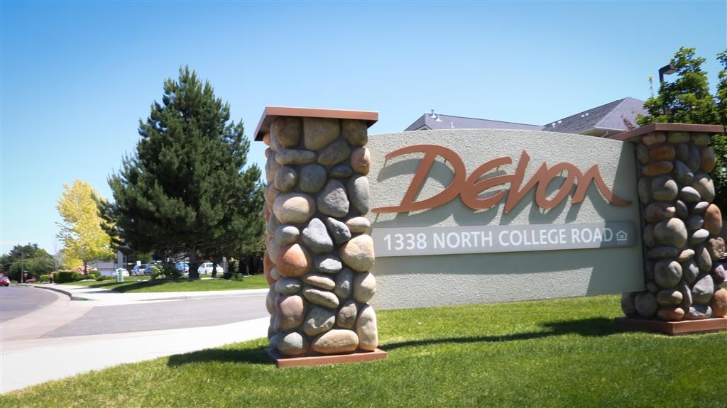 a sign for the delon north college road with rocks on it