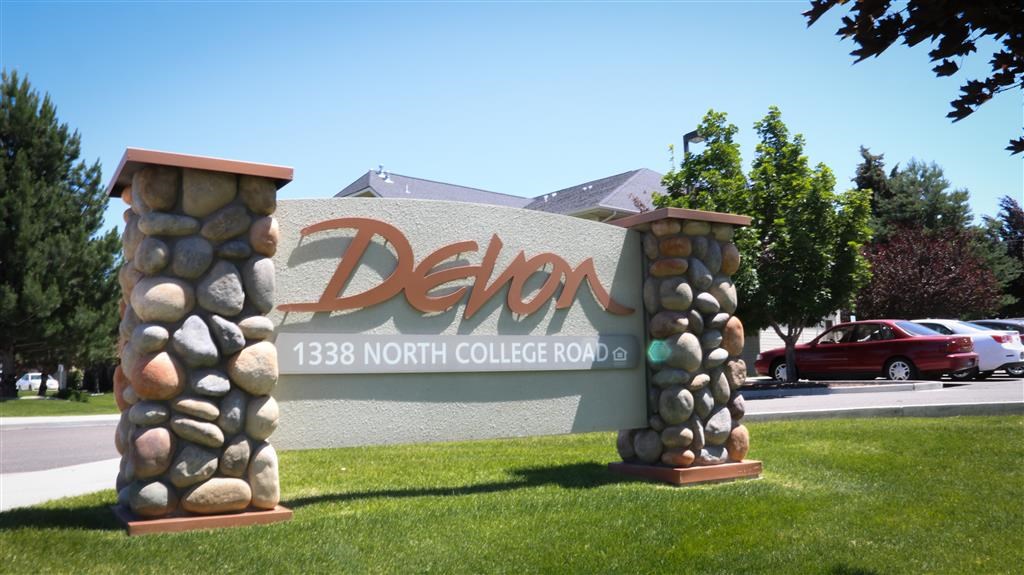 a sign for the delon north college road with rocks on it