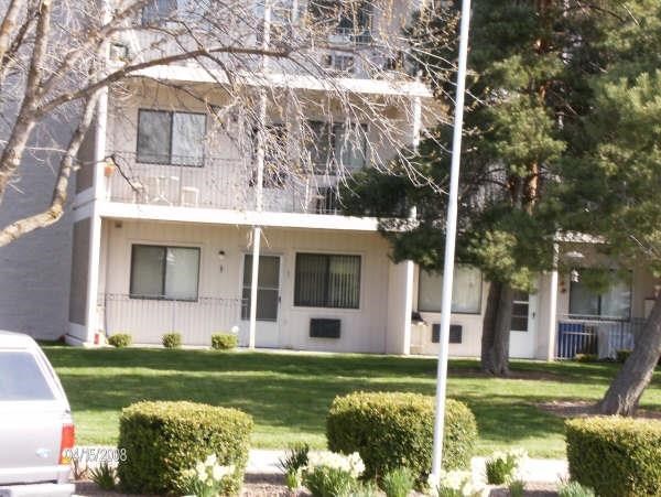 a white house with a car parked in front of it