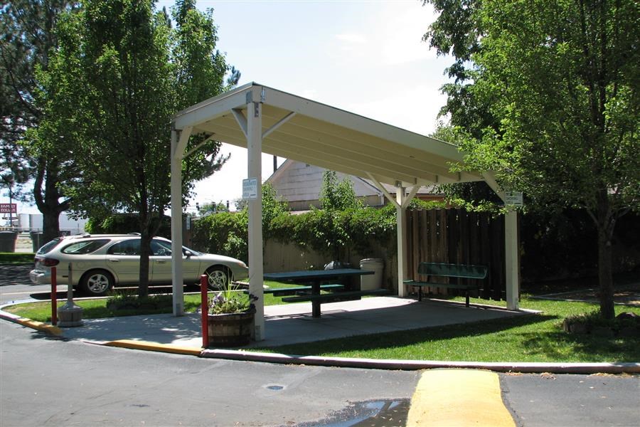 a park pavilion with a bench and