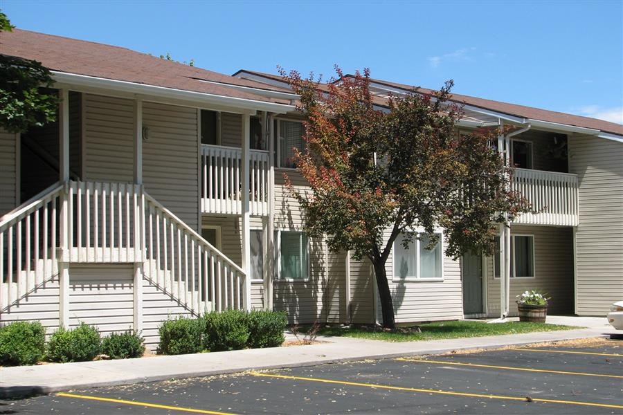 a building with stairs and a tree in front of it