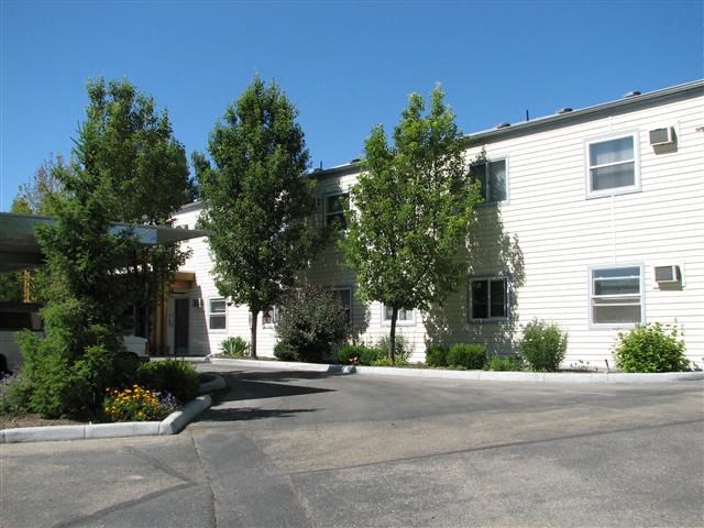 a white building with a street in front of it