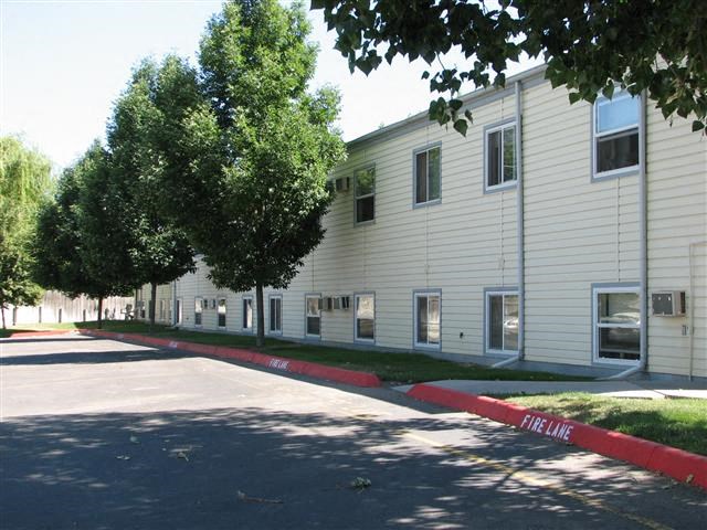 a white building with a red curb in front of it