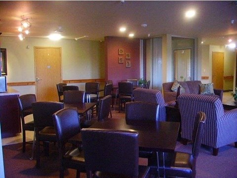 a living room with tables and chairs and a couch