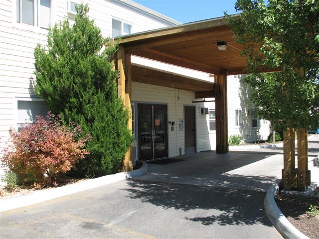 a covered entrance to a building with a driveway
