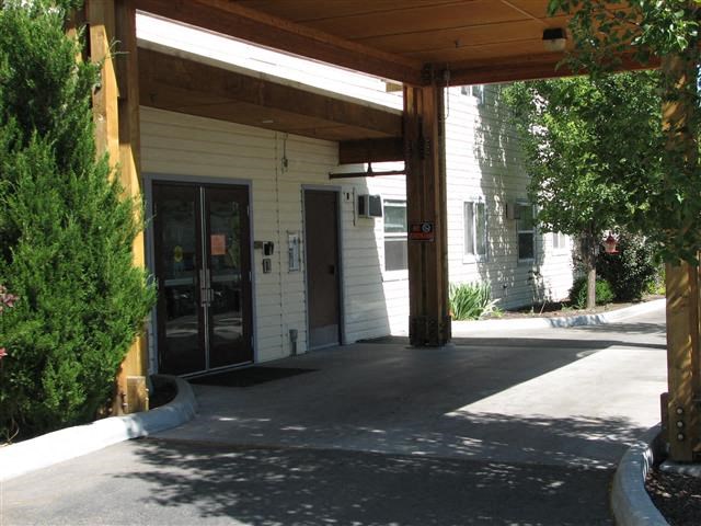 a building with a covered porch and a door
