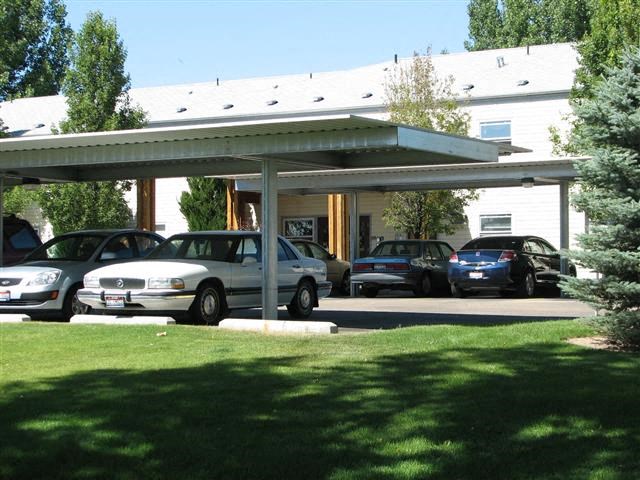 a parking lot with cars parked in front of a building