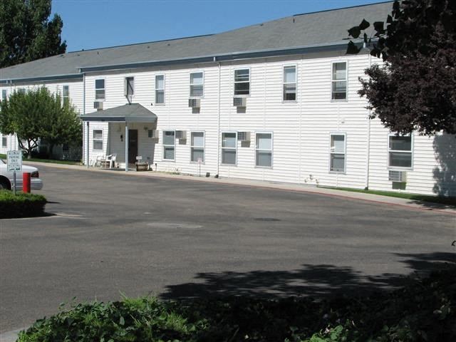 a large white building with a street in front of it