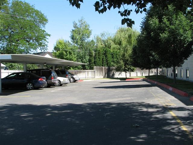 a parking lot filled with cars and a parking garage