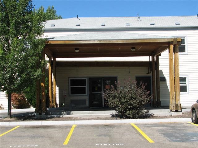 a white building with a covered parking lot