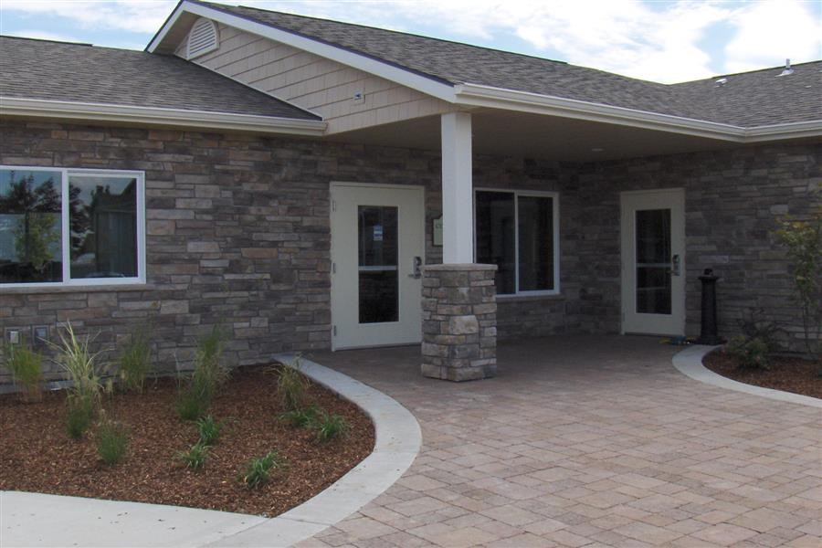 a brick house with a walkway and a front door