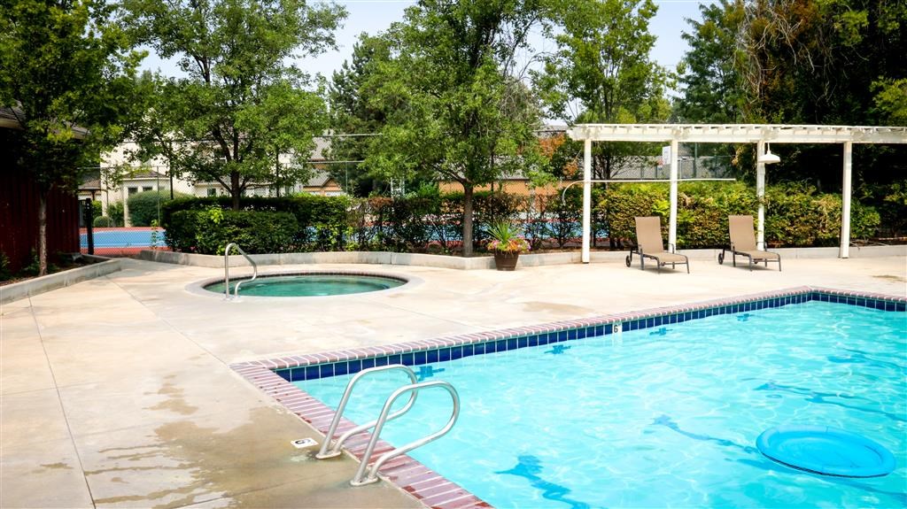 a swimming pool with two pools and two chairs
