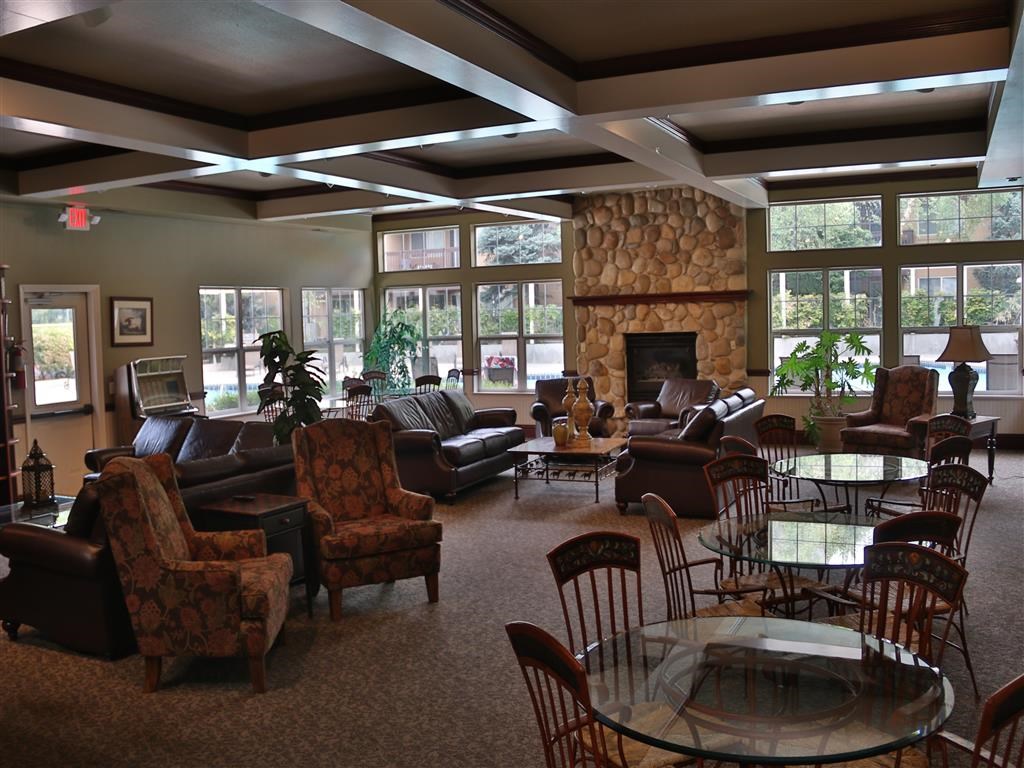 a large living room with couches and chairs and a fireplace