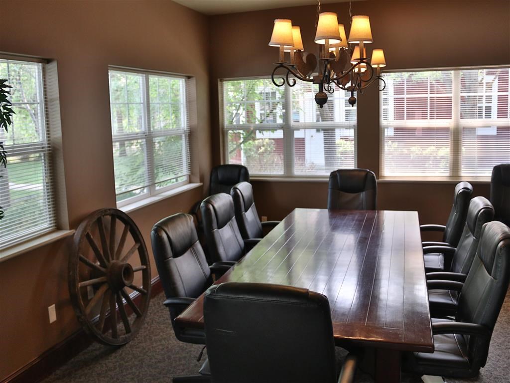 a dining room with a long wooden table and chairs