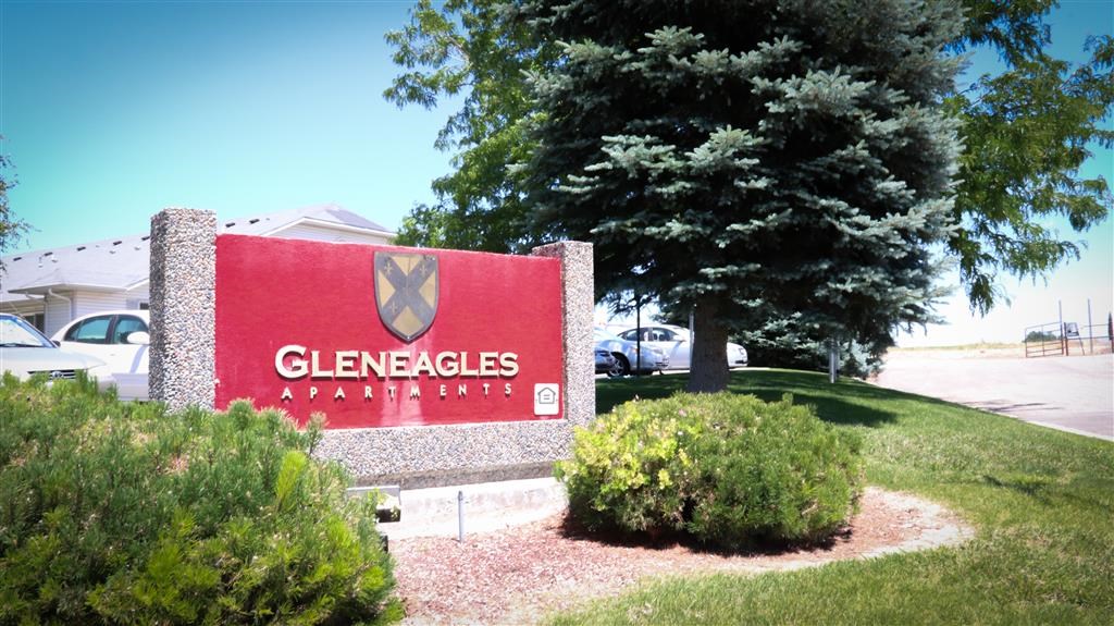 a sign in front of a parking lot