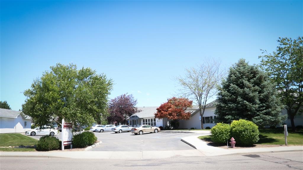 a street with cars parked in front of a house