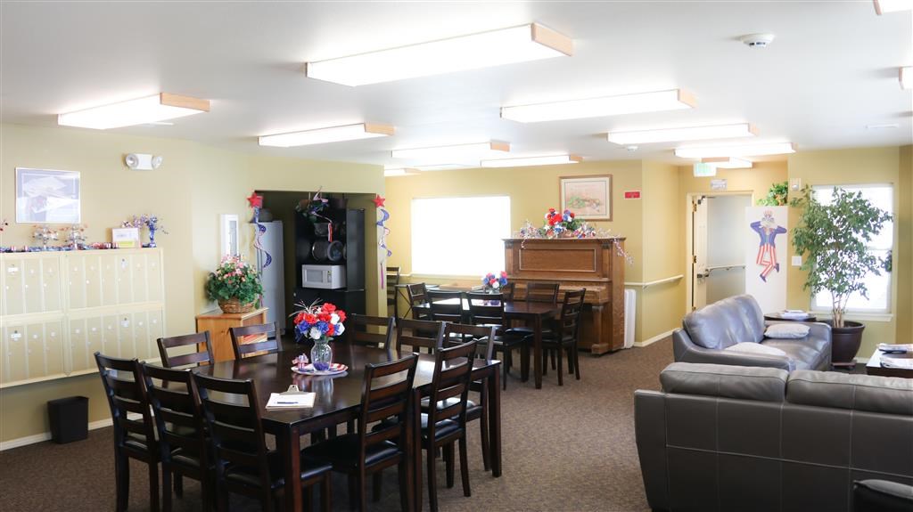 a living room and dining room with a table and chairs