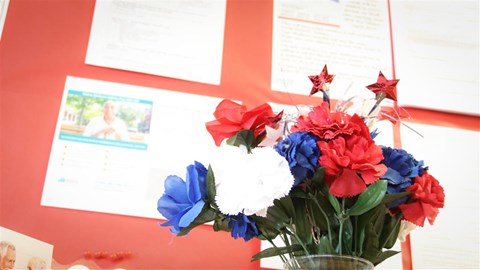 a vase filled with red white and blue flowers