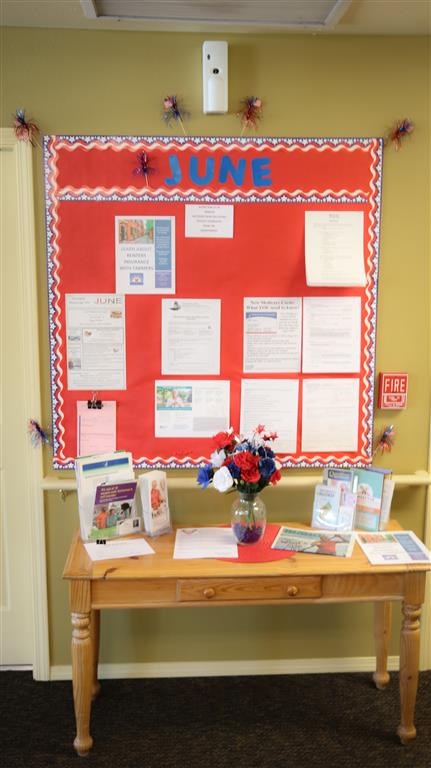 a table with a bulletin board on the wall