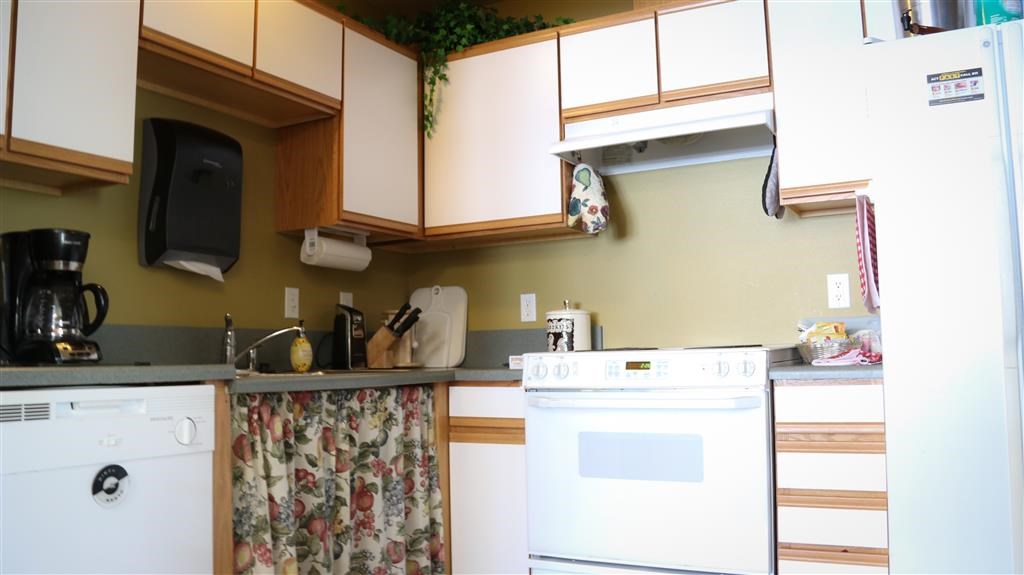 a kitchen with a white stove and a sink