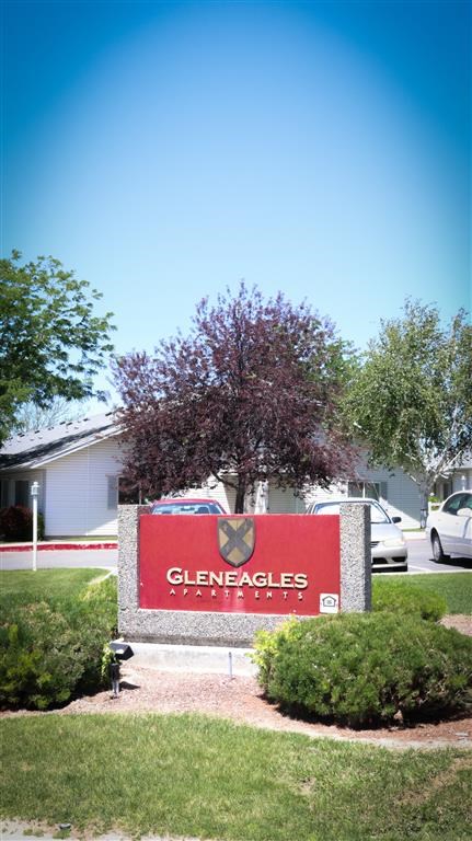 a sign in front of a building with a tree