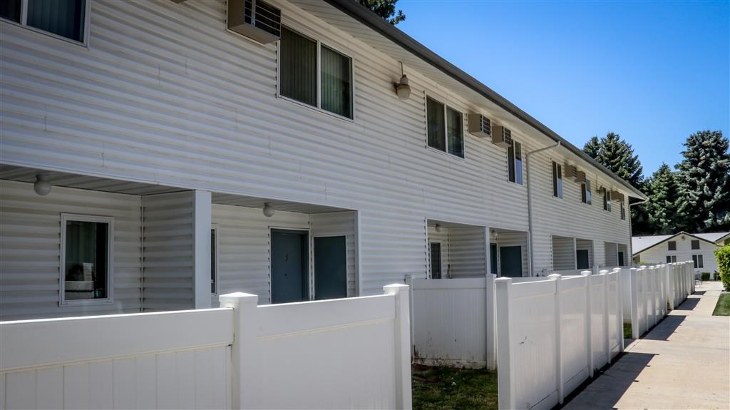 a white house with a white fence in front of it